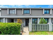 Charming two-story home with a well-maintained front yard, featuring a gray facade, decorative plants and new landscaping at 140 Limewood Pl # C, Ormond Beach, FL 32174