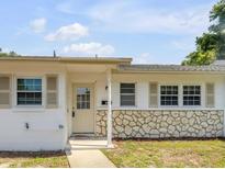 Charming single-story home featuring a stone accent wall and a welcoming front porch entrance at 167 N Hill Ave # 60, Deland, FL 32724