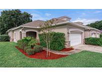 Charming single-Gathering home with manicured lawn, lovely landscaping, and an attached two-car garage at 1983 Turnbull Lakes Dr, New Smyrna Beach, FL 32168