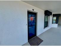 Exterior shot of the condo entrance, featuring a welcome mat and the unit number at 2700 N Peninsula Ave # 322, New Smyrna Beach, FL 32169