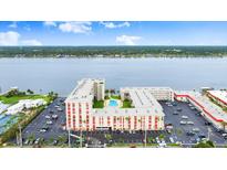 Stunning aerial view of complex with beautiful river scenery, resort pool, and parking at 2711 N Halifax Ave # 372, Daytona Beach, FL 32118