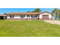 Charming single-story home with a well-maintained lawn, brown accents, and an attached garage at 3044 Pine Tree Dr, Edgewater, FL 32141
