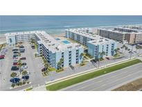Beautiful aerial view of beachside condos with a community pool, parking, and ocean views at 4151 S Atlantic Ave # 3090, New Smyrna Beach, FL 32169