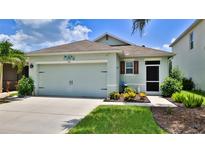 Charming single-story home featuring a two-car garage and well-maintained landscaping at 551 Armoyan Way, New Smyrna Beach, FL 32168