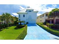 Two story white home with blue driveway and lawn at 6340 Engram Rd, New Smyrna Beach, FL 32169