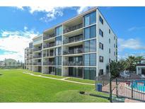 Beautiful condo building with balconies, large windows, and well-maintained landscaping, providing a desirable coastal living experience at 6727 Turtlemound Rd # 318, New Smyrna Beach, FL 32169