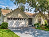 Charming single-story home with a well-manicured lawn, two-car garage, and beautiful mature trees, providing shade and curb appeal at 686 Middlebury Loop, New Smyrna Beach, FL 32168