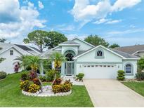 Charming single Gathering home with beautiful landscaping and attached two car garage at 1221 Siesta Key Cir, Port Orange, FL 32128