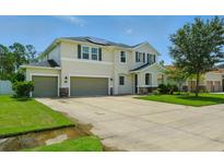 Stunning two-story home with a three-car garage, solar panels, and well-manicured lawn at 19 Abacus Ave, Ormond Beach, FL 32174
