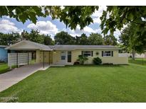 Charming single-story home with a covered carport and a well-maintained lawn at 2009 Brian Ave, South Daytona, FL 32119