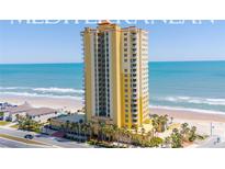Luxury condo building in Daytona Beach with beautiful ocean views, palm trees and coastal elegance at 2300 N Atlantic Ave # 203, Daytona Beach, FL 32118