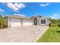 Beautiful single-Gathering home with a three-car garage, stylish stone accents, and a well-manicured front yard at 3027 Portofino Blvd, New Smyrna Beach, FL 32168