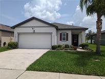 Charming single-story home featuring a well-maintained lawn, attached garage, and beautiful landscaping at 3103 Nova Scotia Way, New Smyrna Beach, FL 32168