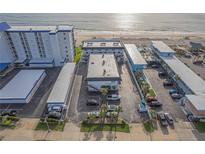 Aerial view of condo building and its proximity to a beautiful sandy beach at 3615 S Atlantic Ave # 211, Daytona Beach, FL 32118