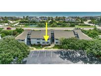 Coastal condo complex featuring lush landscaping, ample parking, and a partial ocean view at 4403 Sea Mist Dr # 109, New Smyrna Beach, FL 32169
