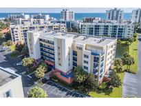 Condo building with balconies overlooking ocean, parking, & green space in a coastal community at 5300 S Atlantic Ave # 11302, New Smyrna Beach, FL 32169