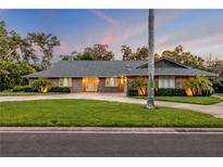 Charming brick home with mature landscaping, well-manicured lawn, and long driveway at 544 Bottlebrush Ct, New Smyrna Beach, FL 32168