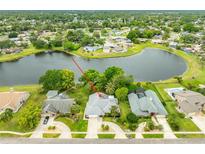 Beautiful aerial view of a home with lush landscaping and a tranquil lake in a desirable neighborhood at 757 Hunt Club Trl, Port Orange, FL 32127