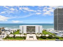 Beautiful oceanfront condo building, lush landscaping, and inviting entryway at 901 S Atlantic Ave # 202, Ormond Beach, FL 32176