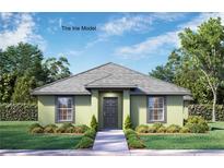 Charming single-story home featuring a well-manicured lawn and neutral-toned facade with a gray roof at 1042 Gary Blvd, Daytona Beach, FL 32119