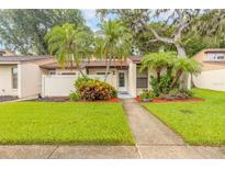 Charming home featuring a well-manicured lawn, beautiful landscaping, and a welcoming entrance at 1237 Charter Oaks Cir, Daytona Beach, FL 32117