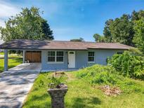 Charming single-story home with a covered carport and tidy front yard at 3045 Pine Tree Dr, Edgewater, FL 32141