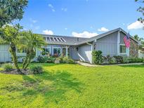 Charming single-story home with a well-manicured lawn, lush landscaping, and inviting curb appeal at 343 Sweet Bay Ave, New Smyrna Beach, FL 32168