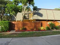 Charming home featuring a well-maintained yard, privacy fence, and lush greenery, creating a cozy and inviting atmosphere at 3824 Saxon Dr, New Smyrna Beach, FL 32169
