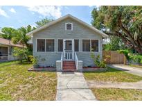 Charming single-story home with gray stone, a screened-in porch, and a well-manicured front lawn at 514 Mary Ave, New Smyrna Beach, FL 32168
