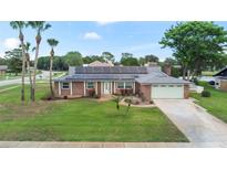 Charming brick home with well-manicured lawn and solar panels offers classic curb appeal at 800 Black Duck Dr, Port Orange, FL 32127