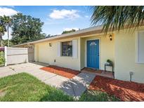 Charming single-story home with a bright blue front door and well-maintained landscaping at 837 Acorn Ln, Port Orange, FL 32127
