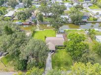 An aerial view of a home with lush green landscaping and waterfront access on a canal, providing serene outdoor living at 154 Godfrey Rd, Edgewater, FL 32141