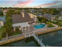 Stunning waterfront home featuring a private pool, covered patio, and a long dock at 1219 Commodore Dr, New Smyrna Beach, FL 32168
