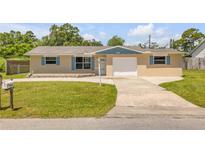 Charming single-story home with a well-manicured lawn and a cozy, inviting appeal at 2416 Pine Tree Dr, Edgewater, FL 32141