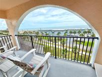 Inviting balcony with chairs overlooks the beach and ocean views at 30 Inlet Harbor Rd # 606, Ponce Inlet, FL 32127