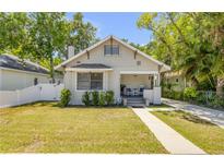 Charming bungalow with well-maintained lawn, inviting front porch, and neutral exterior paint at 402 N Orange St, New Smyrna Beach, FL 32168