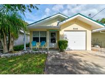 Charming single-story home with a one-car garage, and inviting front porch with seating at 5146 Pineland Ave, Port Orange, FL 32127