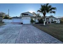 Two-story home with double garage and paved driveway at 3115 Albert St, Orlando, FL 32806