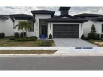 Move-in ready home with a two-car garage and landscaped yard at 3016 Kensington Ave, Davenport, FL 33837
