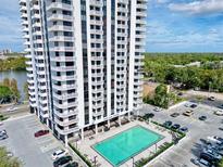 Aerial view of Park Lake Towers showing a sparkling swimming pool and ample parking at 400 E Colonial Dr # 203, Orlando, FL 32803