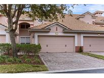 Two-story townhome with double garage and landscaped front at 1323 Gilford Point Ln # 0, Davenport, FL 33896