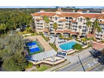A beautiful aerial view of the condominium featuring a pool, tennis court and other amenities at 1110 W Ivanhoe Blvd # 6, Orlando, FL 32804