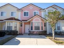 Colorful townhouse exterior showing a well-maintained facade, driveway, and manicured shrubbery at 4712 Hemingway House St, Kissimmee, FL 34746