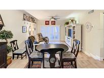 Living room features sliding glass doors and open floor plan to dining area at 750 E Michigan St # 163, Orlando, FL 32806