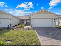 Charming one-story home featuring a manicured lawn, brick driveway, and inviting entrance at 2542 Cliff Way, St Cloud, FL 34771
