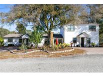 Two-story home with landscaped yard and large tree at 500 Freyer Dr, Longwood, FL 32750