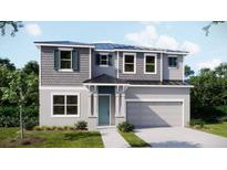 Two-story home with gray siding, neutral accents, and a two-car garage at 1676 Andover Ridge Dr, Deland, FL 32720