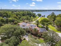 Aerial view showing a home with solar panels and lakefront property at 208 Green Lake Cir, Longwood, FL 32779