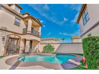Inviting private pool with a patio, lush landscaping, and stylish outdoor seating for relaxation and entertainment at 7459 Excitement Dr, Reunion, FL 34747