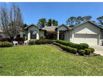 Single-story home with landscaped lawn and attached garage at 5021 Harbor Hts, Lady Lake, FL 32159